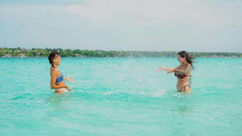 Bacalar Lagoon Sightseeing Boat Tour with Open Bar & Snack - The secret sunset stop: picnic, swimming, and the grand finale feel