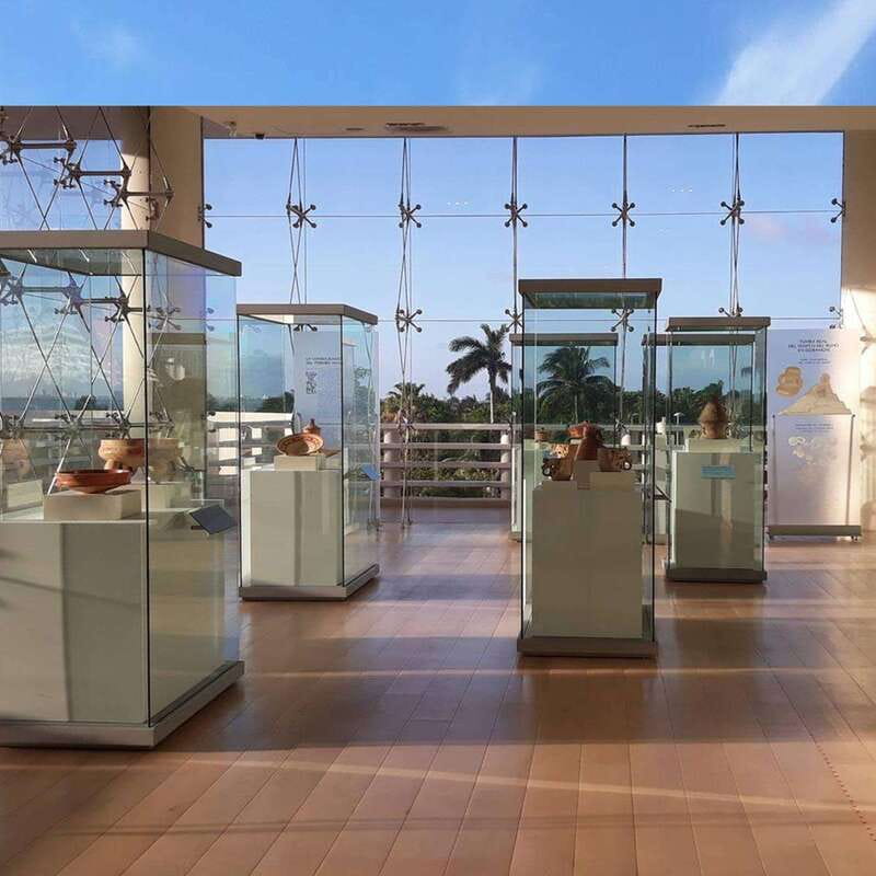 Cancun: Skip-the-Line Mayan Museum & San Miguelito Site - San Miguelito Archaeological Site: Wooden house foundations, palms, and lagoon views