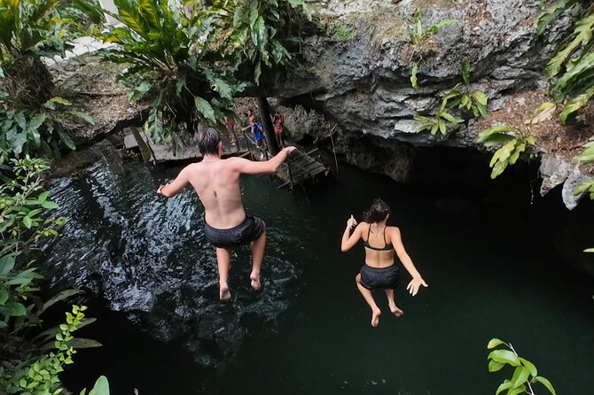 Jade Caverns and Mayan Village Cozumel ATV TOUR - ATV riding on Cozumel dirt roads, with helmets, goggles, and face masks